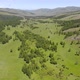 Green Meadows in The Sparsely Wooded Between Forest Covered Hills with Aerial View - VideoHive Item for Sale