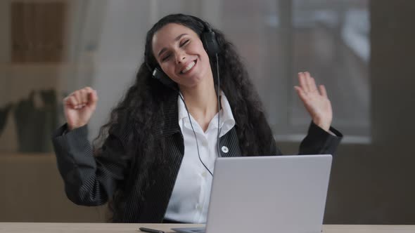 Happy Young Arabian Lady Woman Freelancer in Headphones Listening Loud Music in Headphones Singing