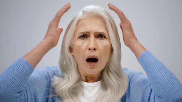 Shocked Senior Woman Crying in Studio