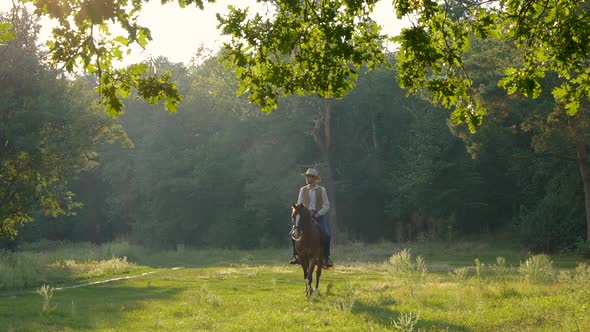 American Cowboy on Horseback on a Forest Lawn