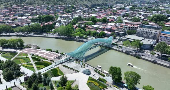 Aerial view of Tbilisi city central park and Bridge of Peace. Beautiful cityscape of old Tbilisi at