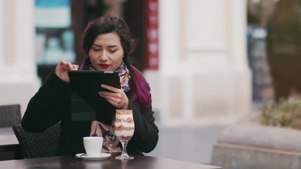 Young Asian Woman Taking Picture of Food in Street Restaurant Using Natural Lighting. Hipster Girl