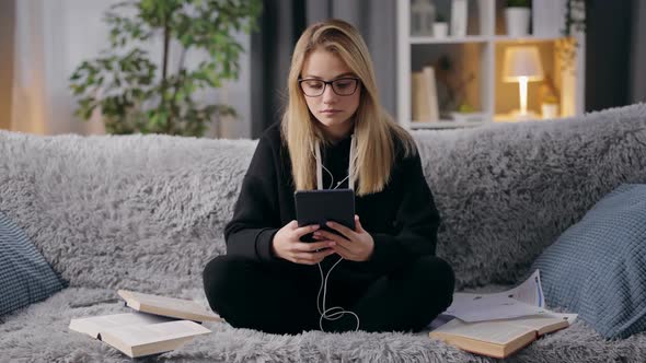 Female Student Using Tablet Couch