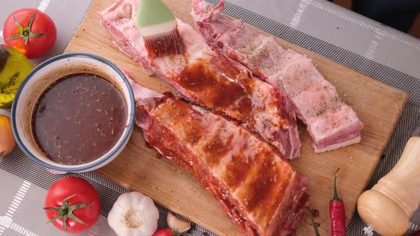 Ribs Get Glazed with Brush with Sweet Barbeque Sauce in Slow Motion Closeup