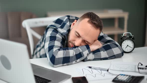 Fatigue Inefficient Man Sleeping Lying on Table with Documents and Laptop