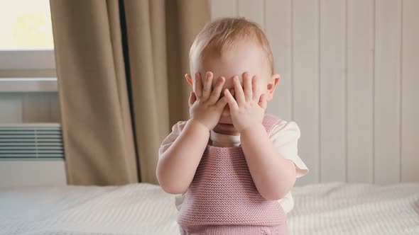 Little Girl Playing Peekaboo Game on Modern Background