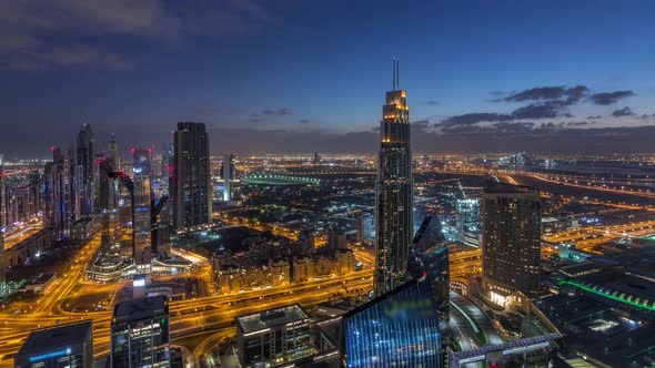 Dubai International Financial Centre District with Modern Skyscrapers Night to Day Timelapse