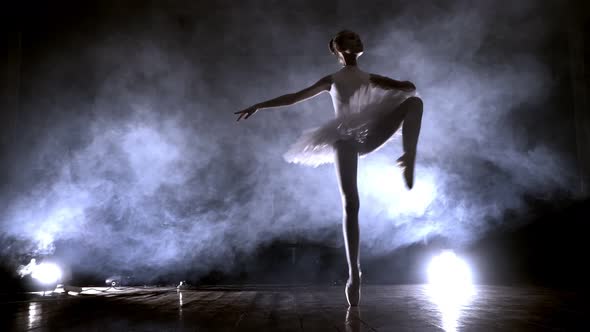 Ballerina Is Practicing Her Moves in Dark Studio