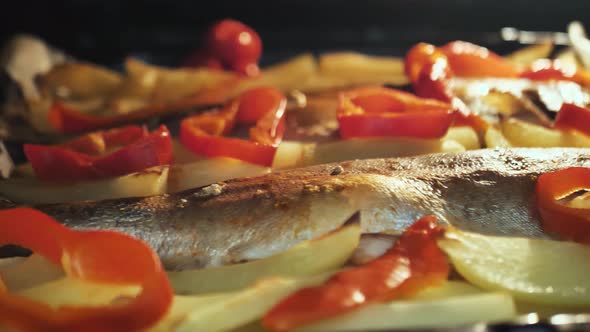 Fish with Vegetables Red Peppers and Potatoes in the Oven