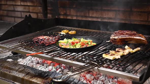 Close Up View of Hand of Male Chef Adding Salt To Delicious Meat Steak on Hot Grill While Cooking It