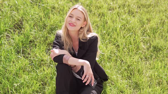 Female Manager Relaxing on Lawn