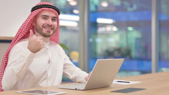 Thumbs Up By Positive Arab Businessman Working in Office 