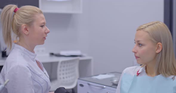 Beautiful Woman Doctor Gives Consultation to a Patient Talks About Dentifrices