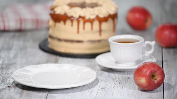 Piece of Caramel Apple Cake with spices, cinnamon, creamy caramel in autumn style