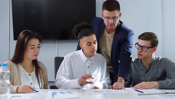 Startup Team Discussing Progress at Meeting