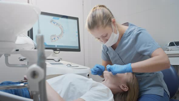 Doctor Woman Makes a 3d Scan of the Teeth of a Female Patient