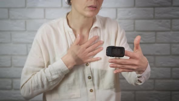 Sick Woman Checking Oxygen Level on Finger