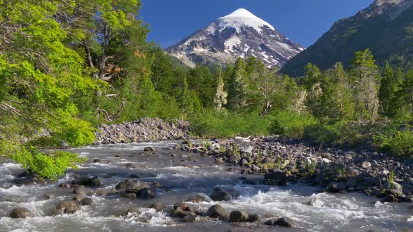 Lanin Volcano in Lanin National Park. Landscape with Volcano, Mountain River and Green Trees