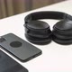 close up video of two dark smartphone and headphones on a white table - VideoHive Item for Sale