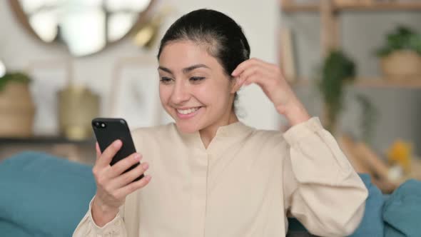 Indian Woman Celebrating on Smartphone at Home 