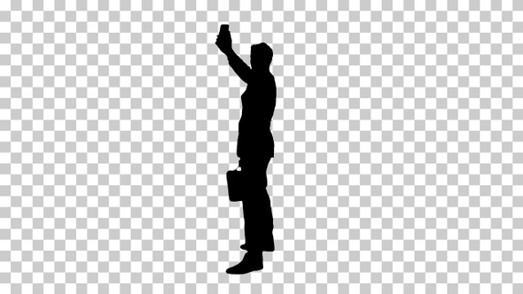 Silhouette Young business man walking and taking a selfie