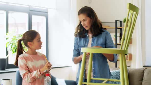 Mother and Daughter with Ruler Measuring Old Chair