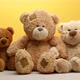 group of cute brown teddy bears sit on yellow background - VideoHive Item for Sale