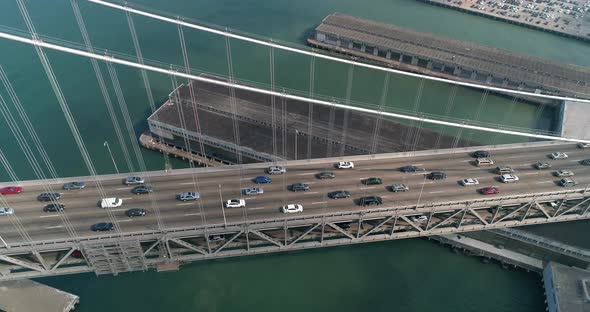 Aerial shot of vehicles moving on San Francisco–Oakland Bay Bridge with city in background