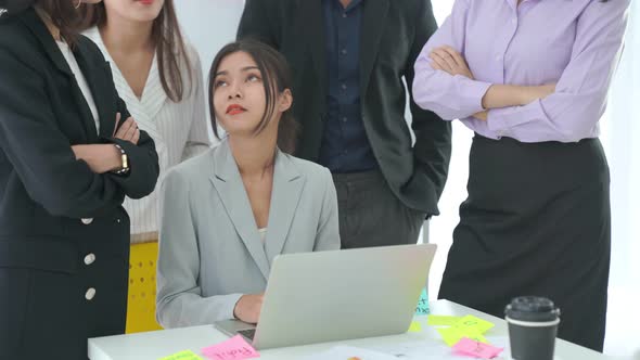 Business People Proficiently Discuss Work Project on Computer