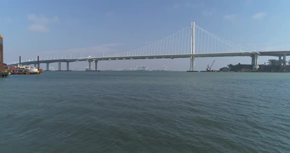 Aerial shot of vehicles moving on San Francisco–Oakland Bay Bridge with city in background