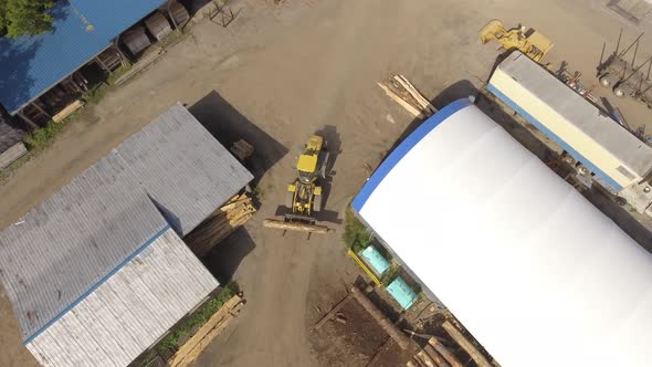 aerial lumber yard tractor transporting giant log 4k