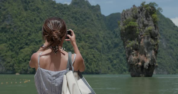 Woman take photo on Khao Phing Kan in thailand, phuket