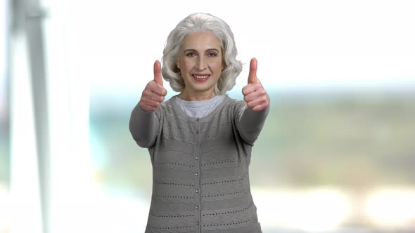 Happy Senior Woman Giving Two Thumbs Up.