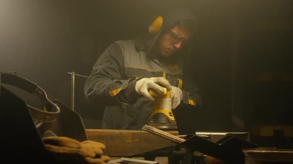 Worker polishing metal with grinder