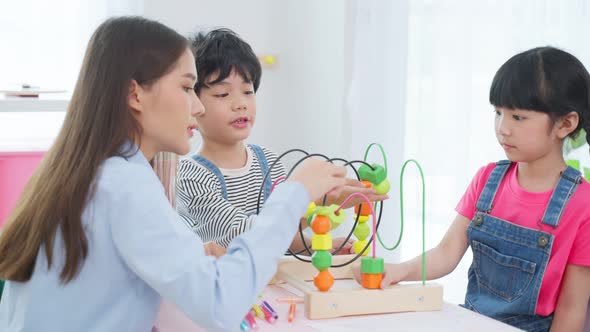 Asian beautiful young woman teacher teaching a lesson to kid in classroom at preschool kindergarten