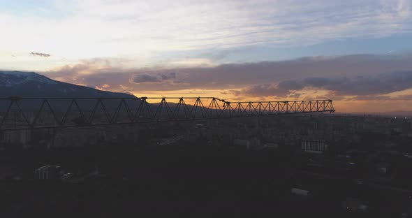 Tower Crane Arm Against Sunset Sky and Colorful Clouds