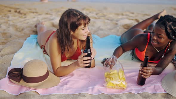 Two Lovely Different Races Girls Sunbathing on Beach