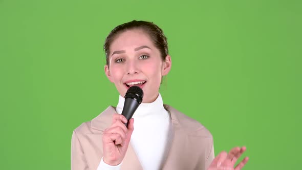 Girl Sings a Cheerful and Melodic Song. Green Screen