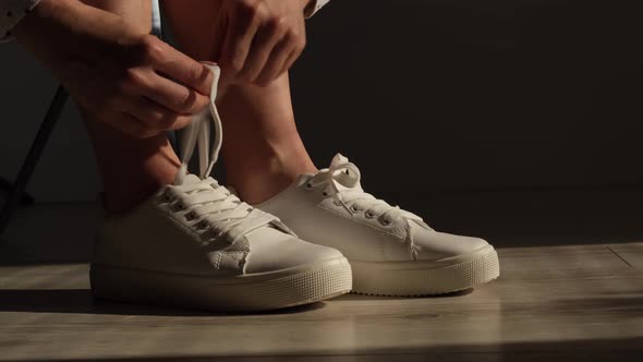 Woman Put on New White Leather Sneakers