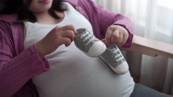 Happy Pregnant Woman and Expecting Baby at Home