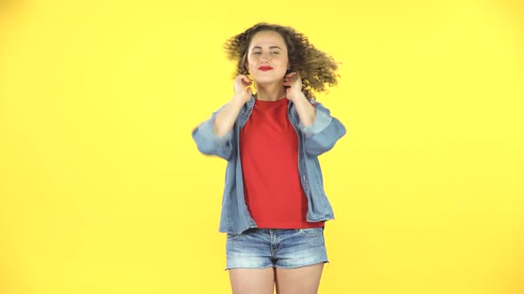 Happy Curly Woman Waving Her Head and Looking at the Camera