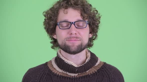 Face of Happy Young Bearded Man Relaxing with Eyes Closed