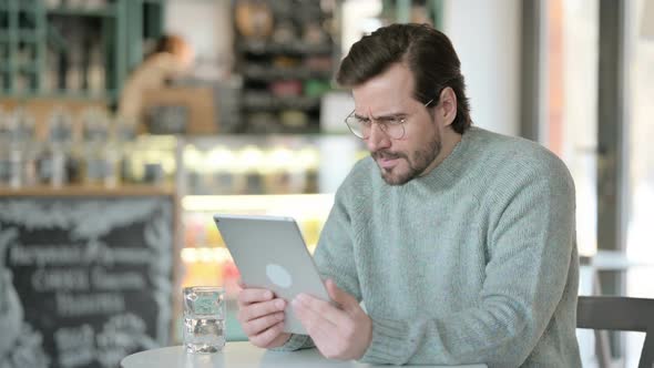 Disappointed Young Man Having Loss Tablet