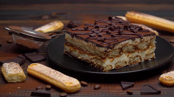 Portion of Traditional Italian Tiramisu Dessert Coffee Beans and Savoiardi Cookies