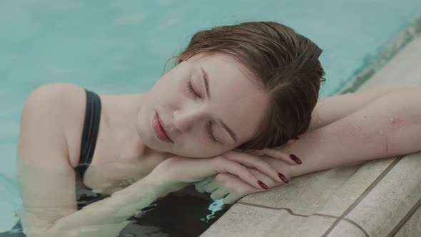 Serene Young Woman Resting in Pool