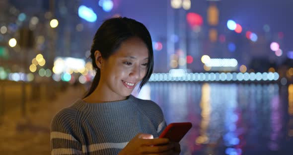 Asian Woman Use of Mobile Phone at Night