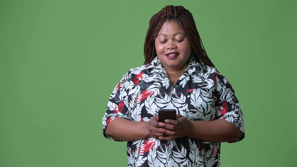 Overweight Beautiful African Woman Against Green Background