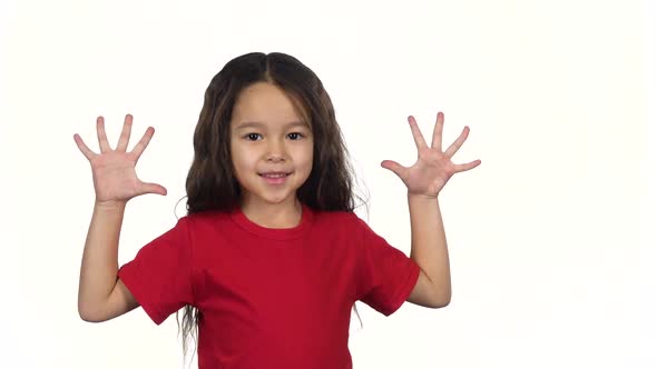 Little Female Up Her Hand on White Background. Slow Motion