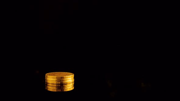 Stop motion Coins Graph.Gold Coins on stack turning on black background