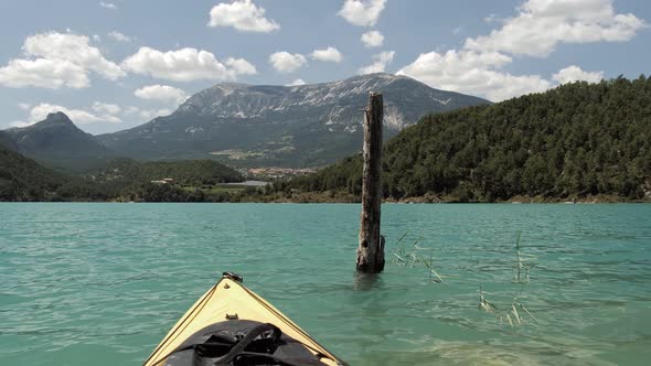 Kayaking on an Emerald Lake with Mountain Background